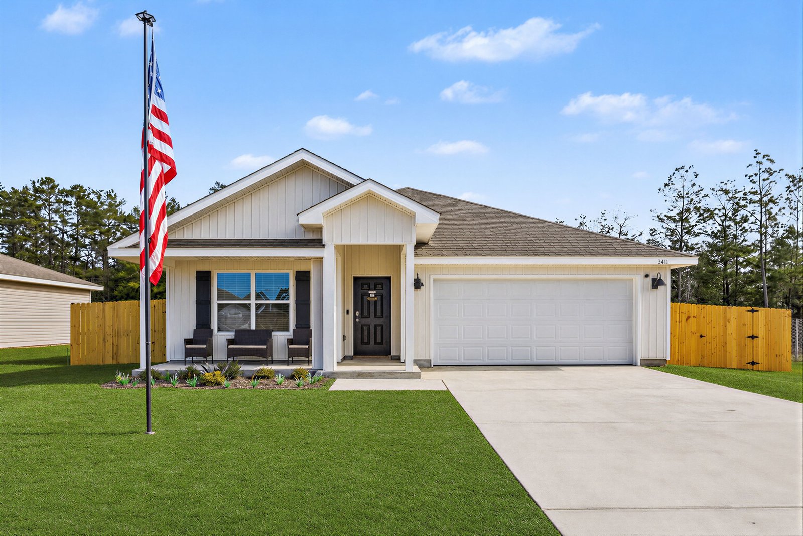 The same home with a lush green replaced front lawn