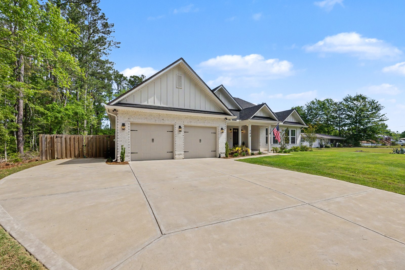 Brick Craftsman family home with manicured lawn